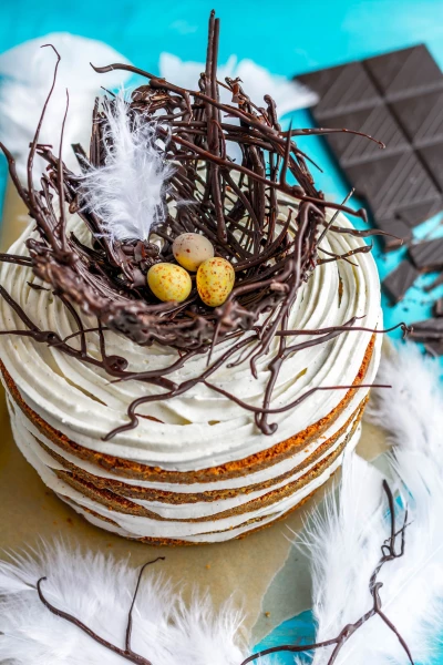 This picture is a result of trying out some chocolate decoration. The final product is a bird’s nest on top of a cake that’s specifically made for the easter time. The styling is completed with the feathers. The mama bird is absent, but the eggs are safe in the nest. The color theme embodies the springtime.