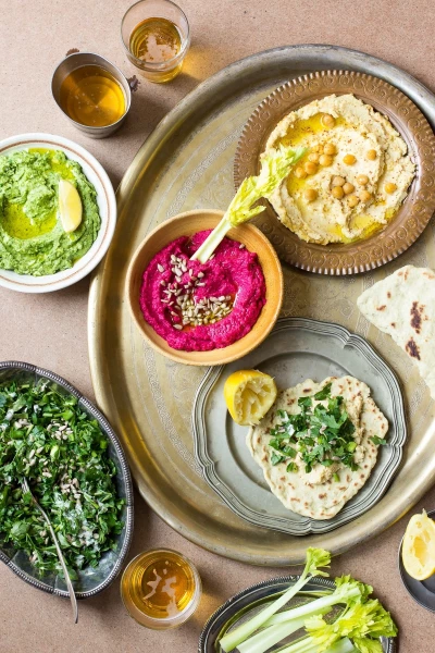 This is a photo of colorful hummus party, which I prepared for the carnival. The menu consists of traditional hummus, pink beetroot hummus with cumin seeds, green spinach hummus with feta and Greek parsley salad with tahini dressing. I wanted to emphasize the vibrant colors of the hummus, especially of the pink beetroot hummus.