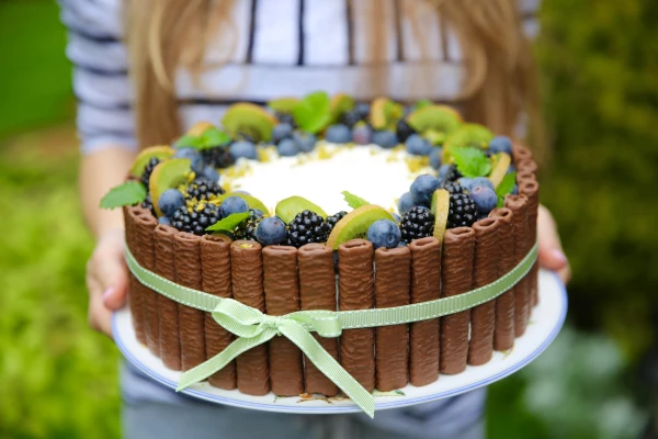 Children’s day cake topped with forest fruits.