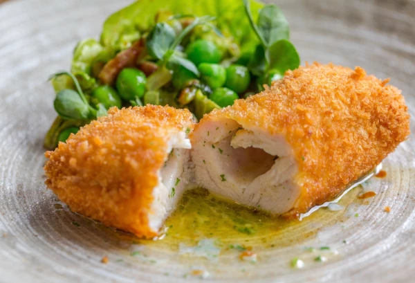 Chicken Kiev, Peas and Mint by Chef Tom Kerridge and team at The Coach in Marlow UK.