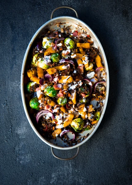 Celebrating the spirit and colors of the fall season,  roasted veggies of brussels sprouts and sweet pumpkins fragrantly flavored with garam masala spice, honey and dijon mustard and then tossed with wild rice and sprinkles of bacon bits.  A dressing of creme fraiche whisked with lemon juice is a must on top!