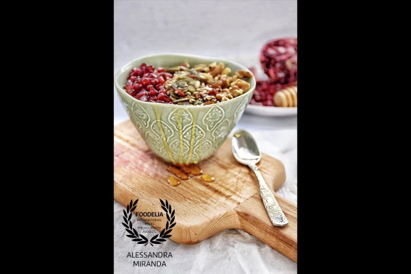 Oatmeal with pomegranate, nuts and honey. It's such a joy for me to shoot fresh ingridients at natural light! To add more texture to the picture I chose an old wood board and a crumpled paper. 