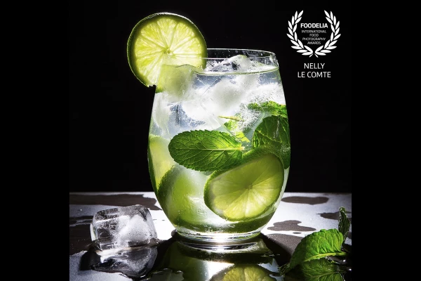 Refreshing gin and tonic with mint and lime. Photographed in the studio, using flashlight from behind to shine through the glass, lime and ice-cubes. Had to work reasonably fast as I do prefer working with real ice-cubes. A great and fun day working.